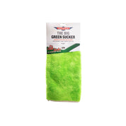 Green cleaning pad with packaging labeled 'The Big Green Sucker' on a white background